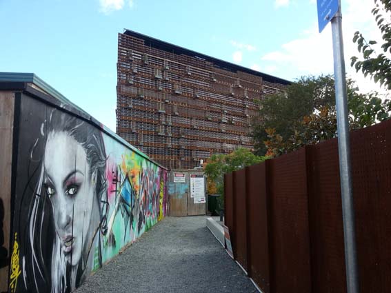 East facade of the Nishi Building along with some of the graffiti art on the building site hoardings