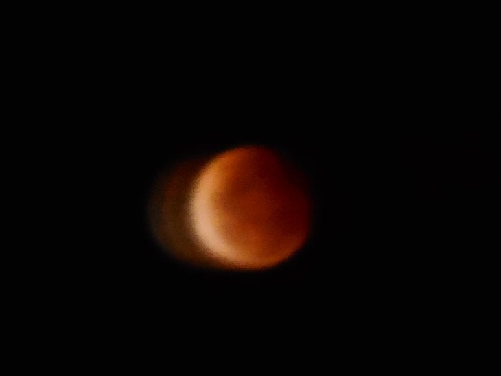 On the upper right hand side of the photo you can just make out a darker red shadow starting to move across the face of the moon. 8.53pm EDST, 8 October 2014